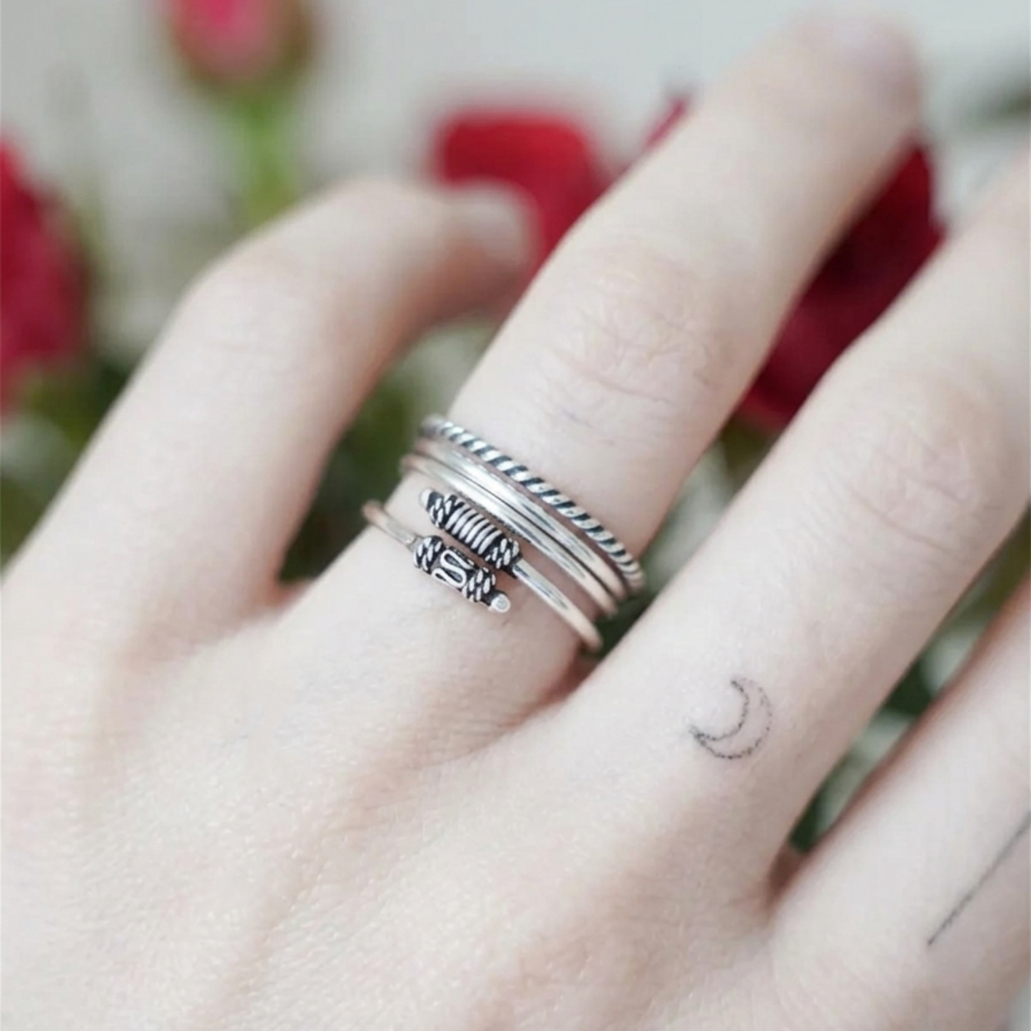 Oxidised Totem Knot ring on finger, silver tone multi-band with braided knot detail