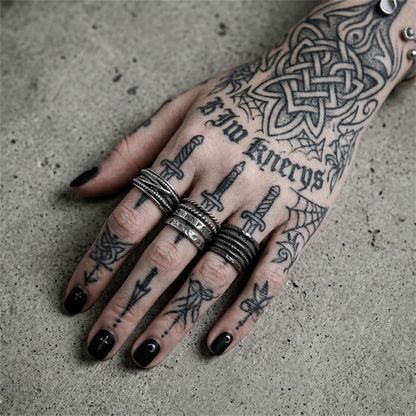 Oxidised rope crossover ring on tattooed hand, stacked rope bands with crossover
