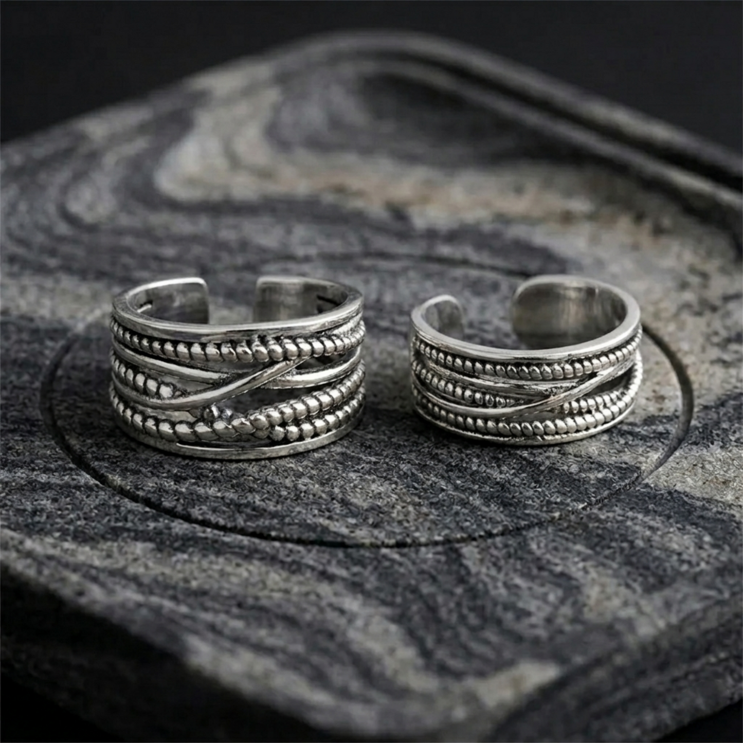 Two oxidised rope crossover rings, close view of stacked rope bands