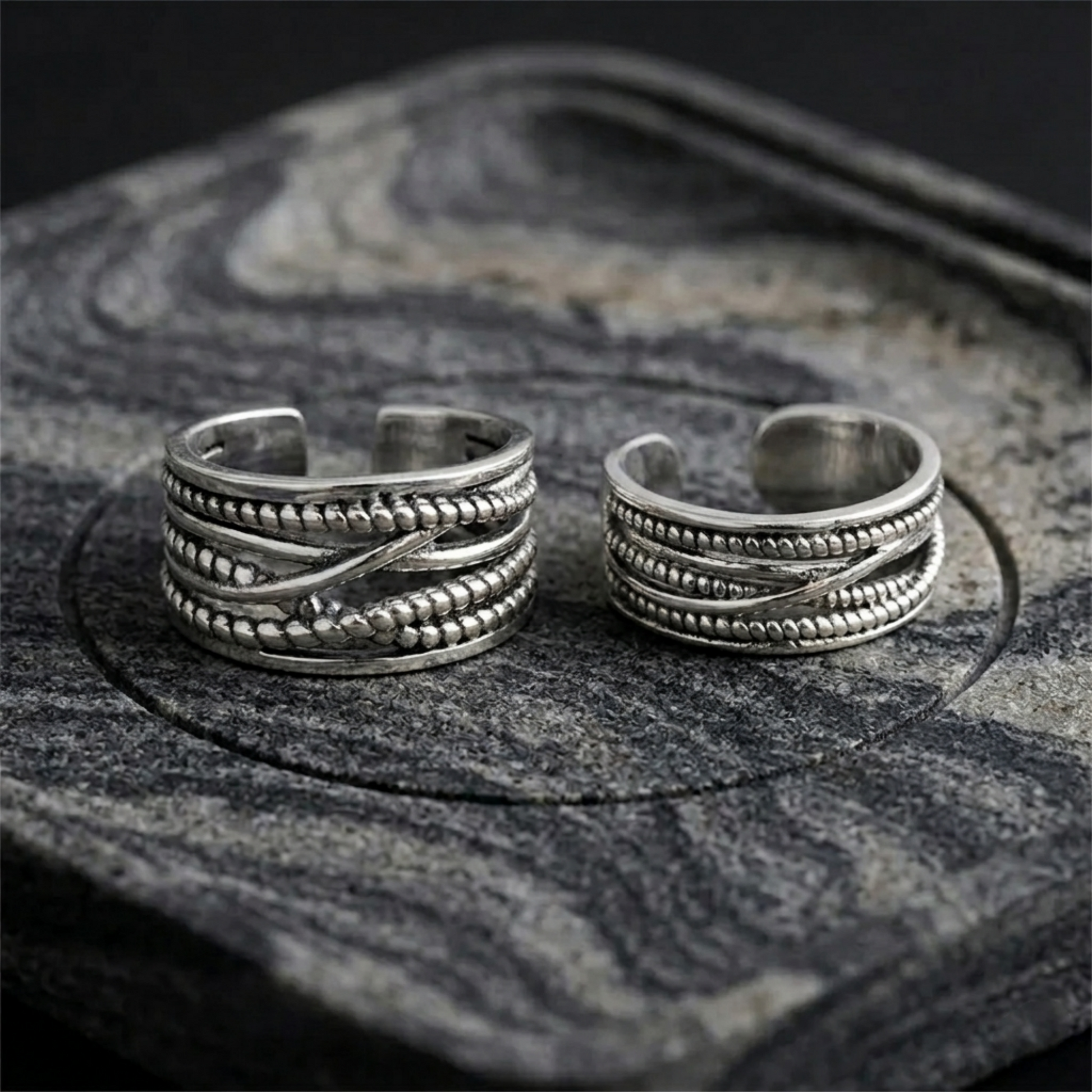 Two oxidised rope crossover rings, close view of stacked rope bands
