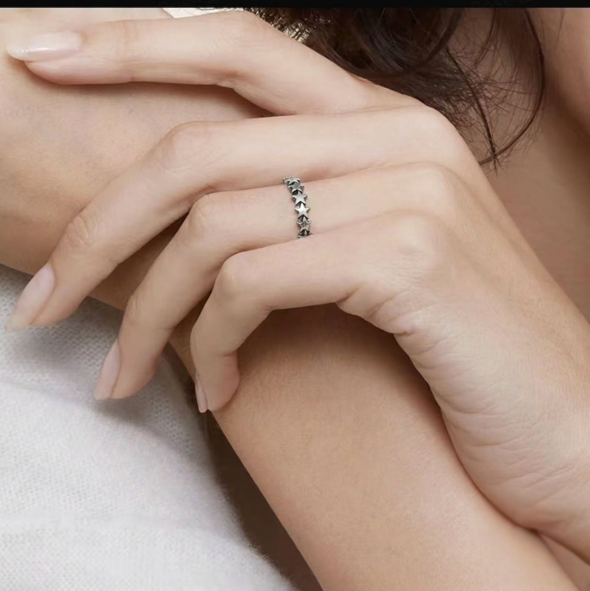 Oxidised linked stars ring on hand, stacked star-link band in silver tone