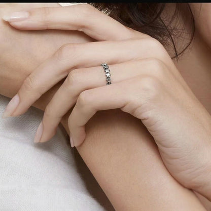 Oxidised linked stars ring on hand, stacked star-link band in silver tone