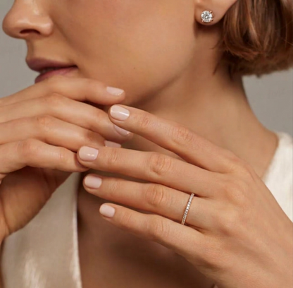 Rhodium pavé stack ring close-up on hand, delicate pavé row across the hoop.