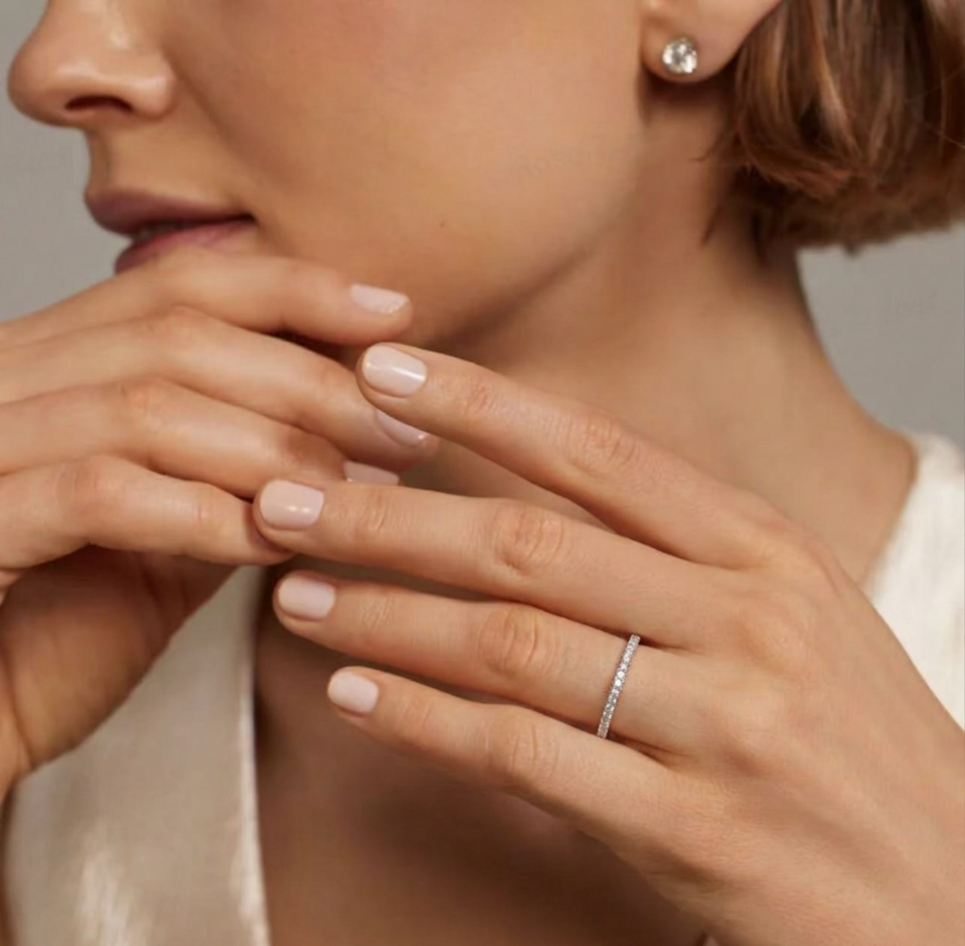 Rhodium pavé stack ring worn on hand, small stones on a slim continuous band.