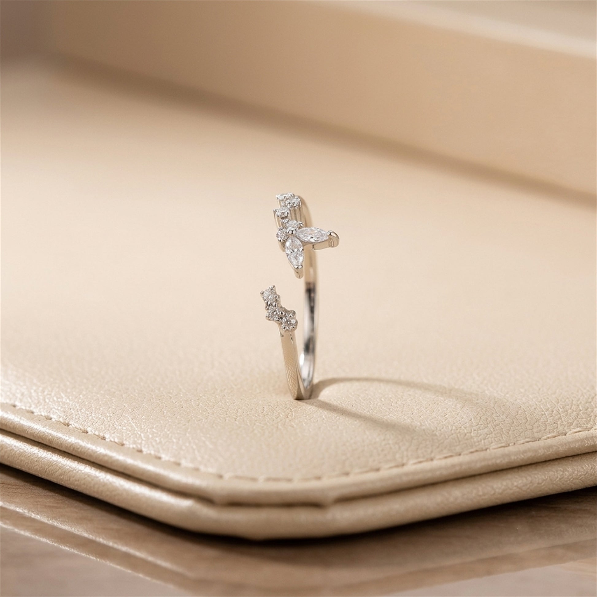 Silver CZ butterfly ring, side view with butterfly stone accents on band