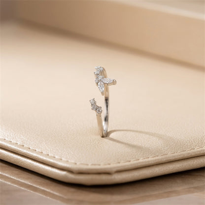 Silver CZ butterfly ring, side view with butterfly stone accents on band