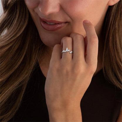 Silver CZ butterfly ring on finger with delicate band and butterfly stones