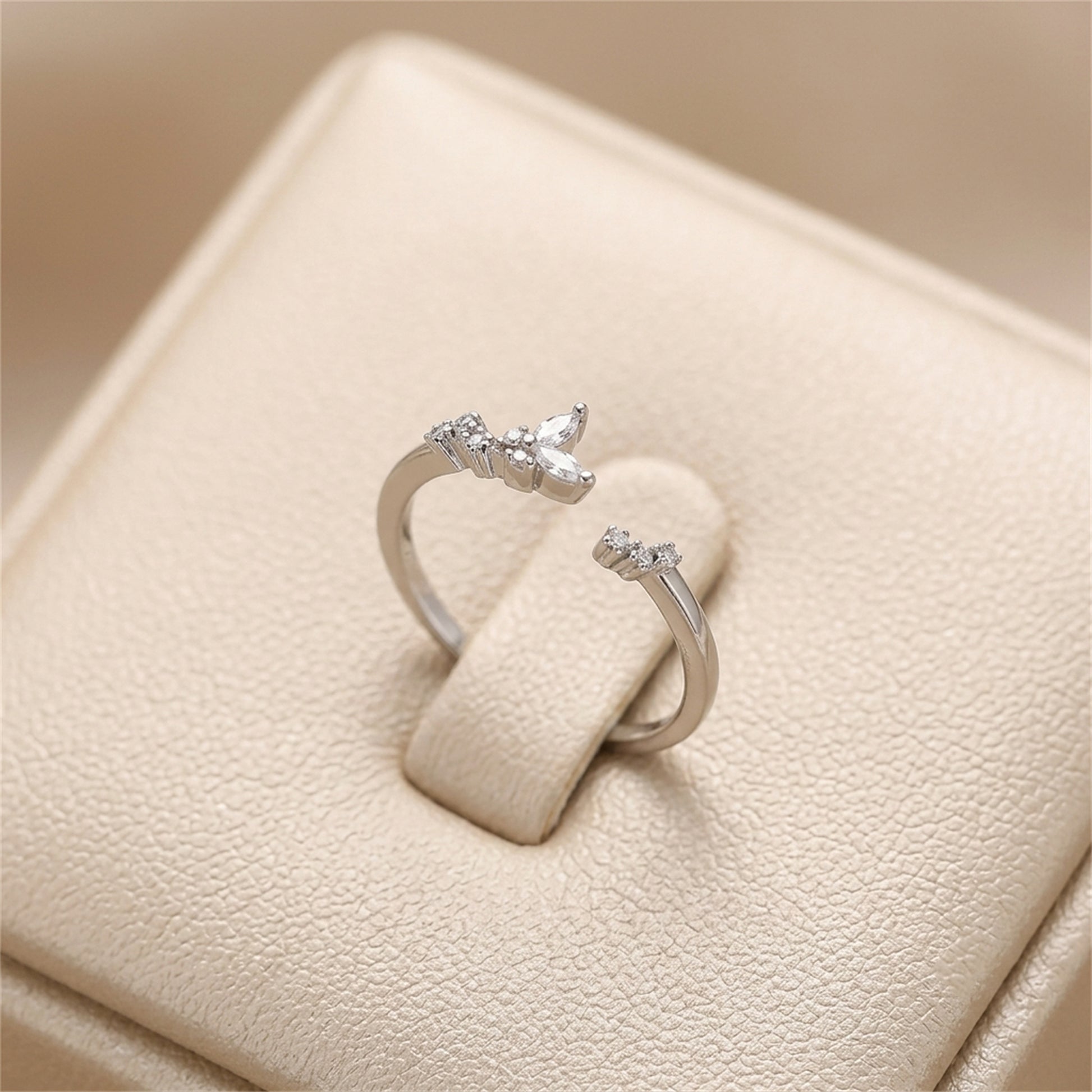 Silver CZ butterfly ring with three small butterfly stones on slim band