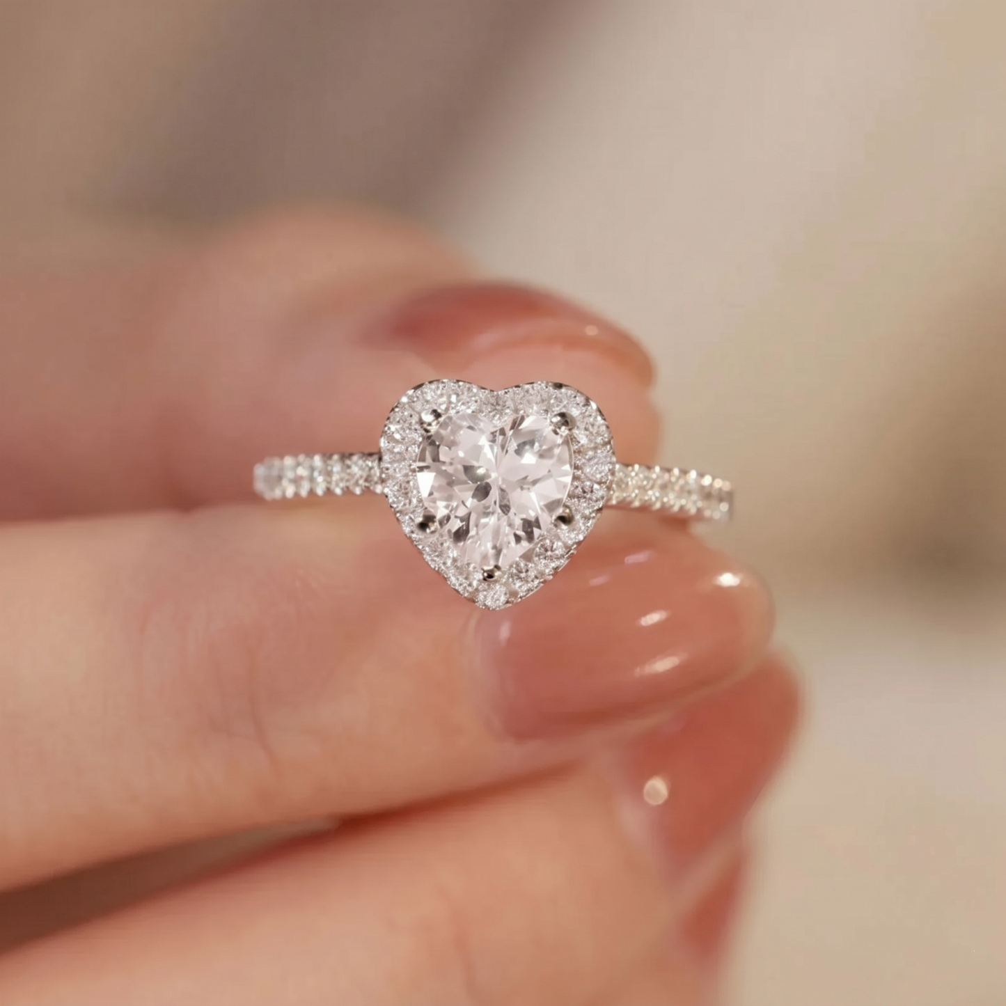 Heart Halo Ring on finger: heart-shaped halo around the central stone, pavé details