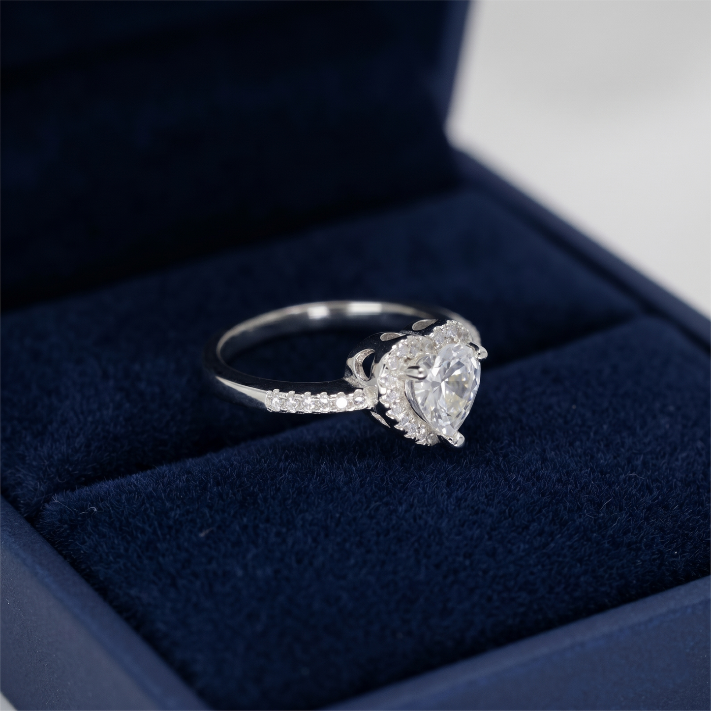Heart Halo Ring side view: heart center with halo stones and pavé band
