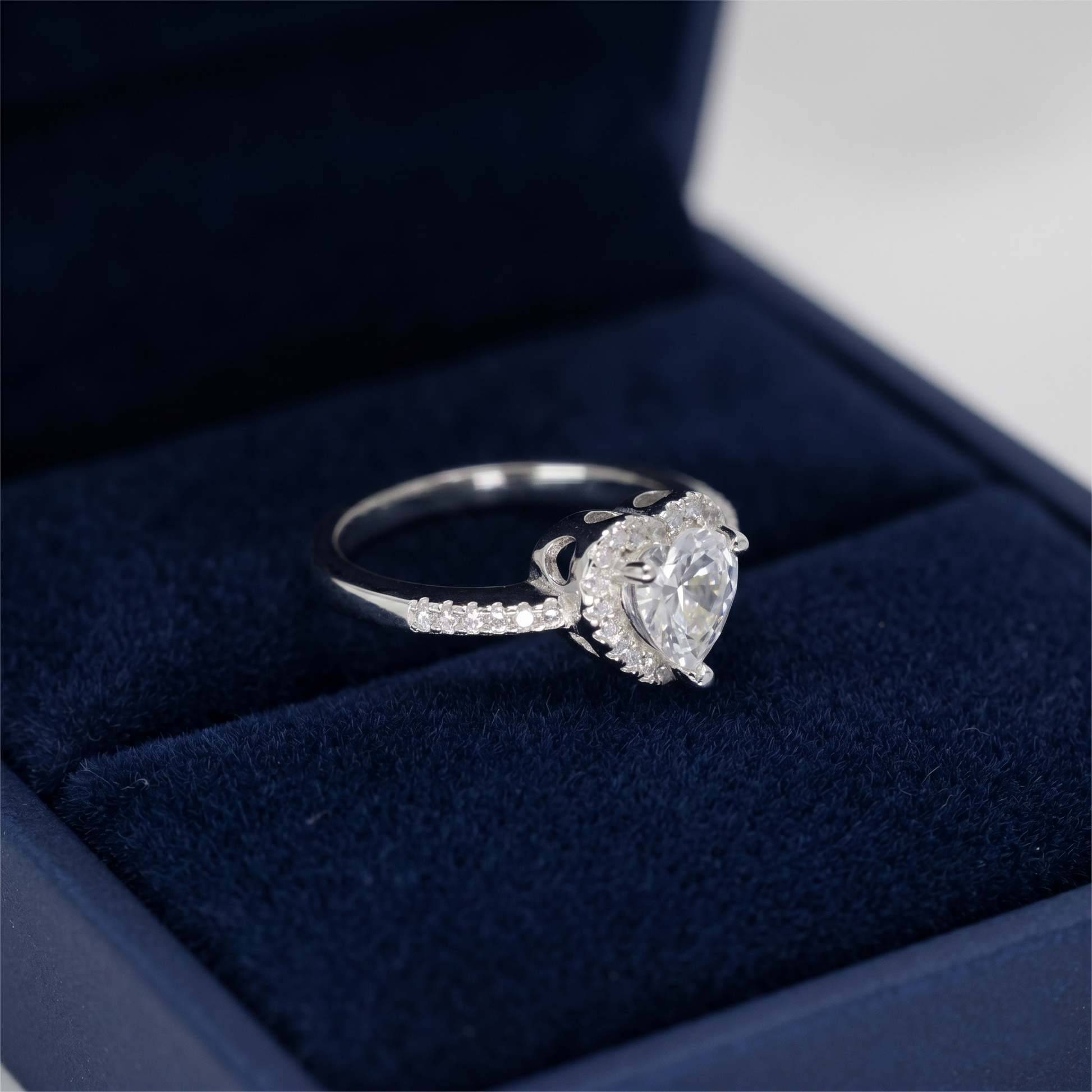 Heart Halo Ring side view: heart center with halo stones and pavé band