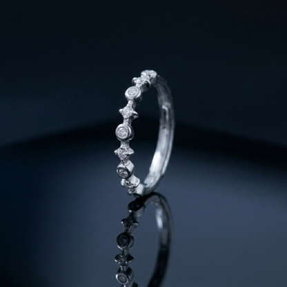 Silver CZ ring with linked star bezels and round stones along the band