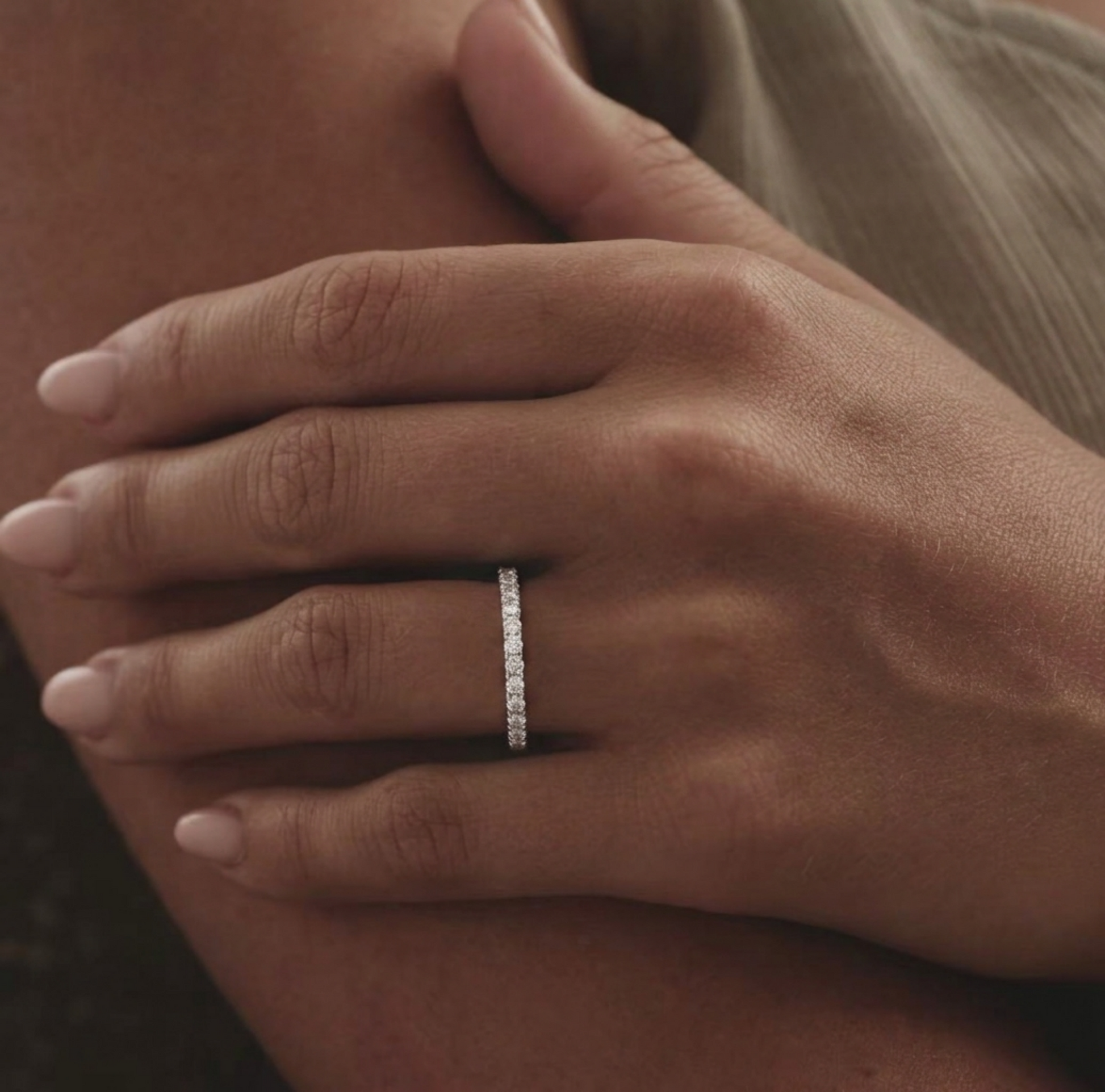 Rhodium CZ stacking eternity band on finger, pavé stone row all around