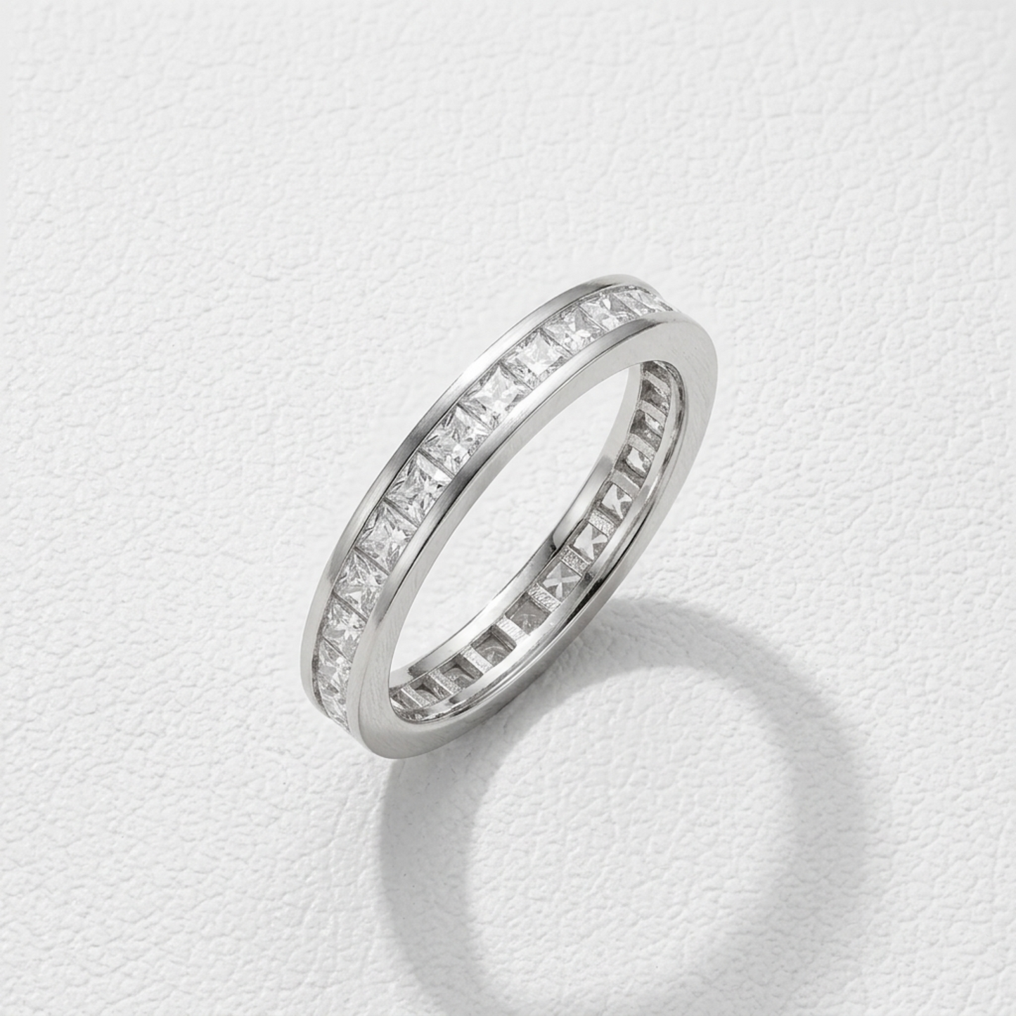 Princess Eternity Ring angled view with princess-cut stone row around the band