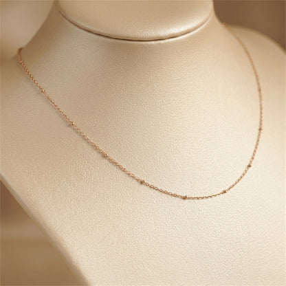 Rose gold flat beaded satellite chain necklace with smooth linked center section