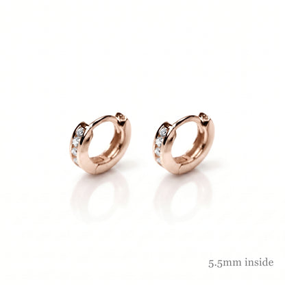 Rose Gold Channel Huggie Hoops with clear stones on the front bands