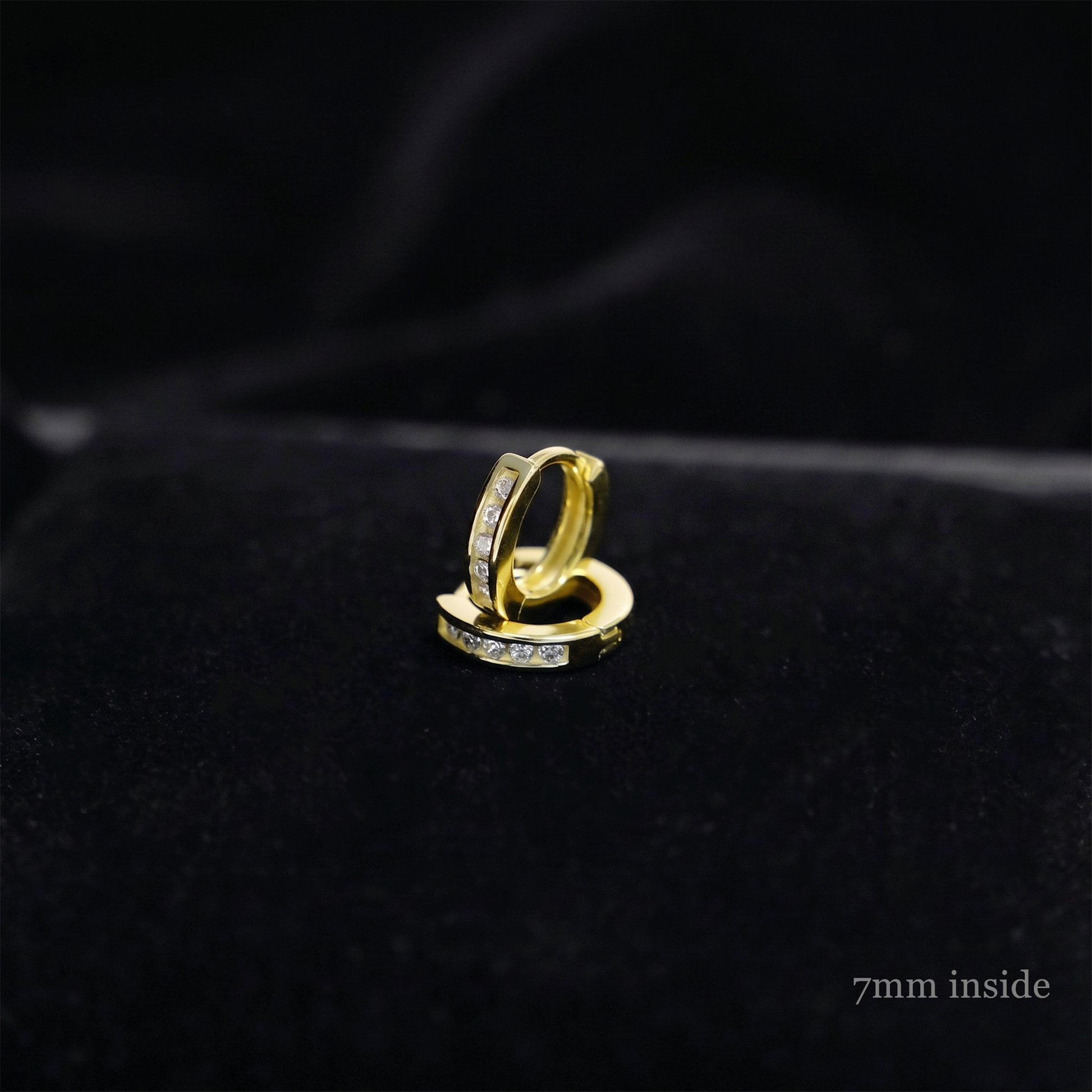 Channel Huggie Hoop earring, gold tone with clear stones; 7mm inside close-up