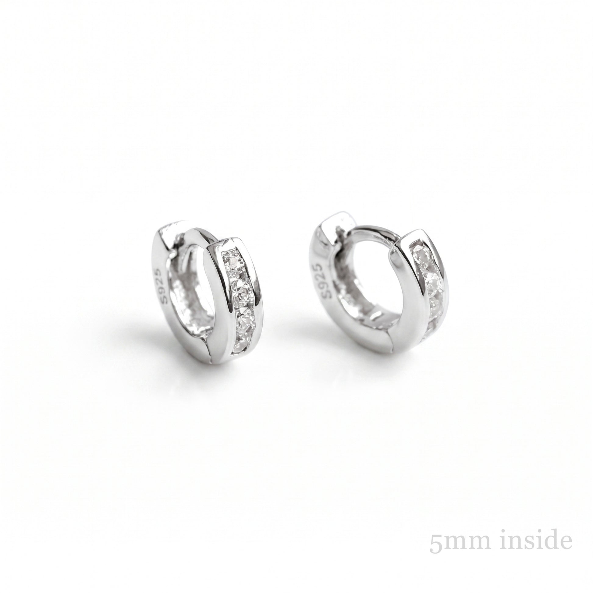 Channel Huggie Hoops in rhodium silver with clear stone detailing
