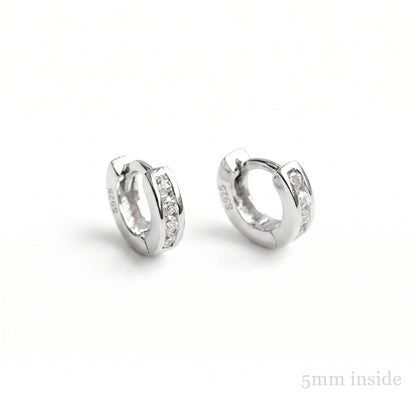 Channel Huggie Hoops in rhodium silver with clear stone detailing