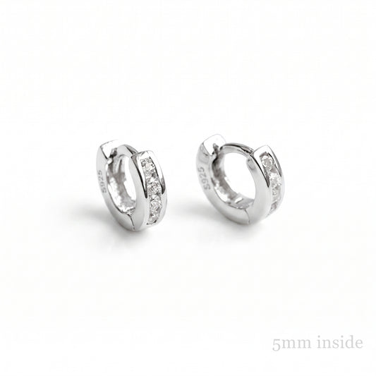 Channel Huggie Hoops in rhodium silver with clear stone detailing