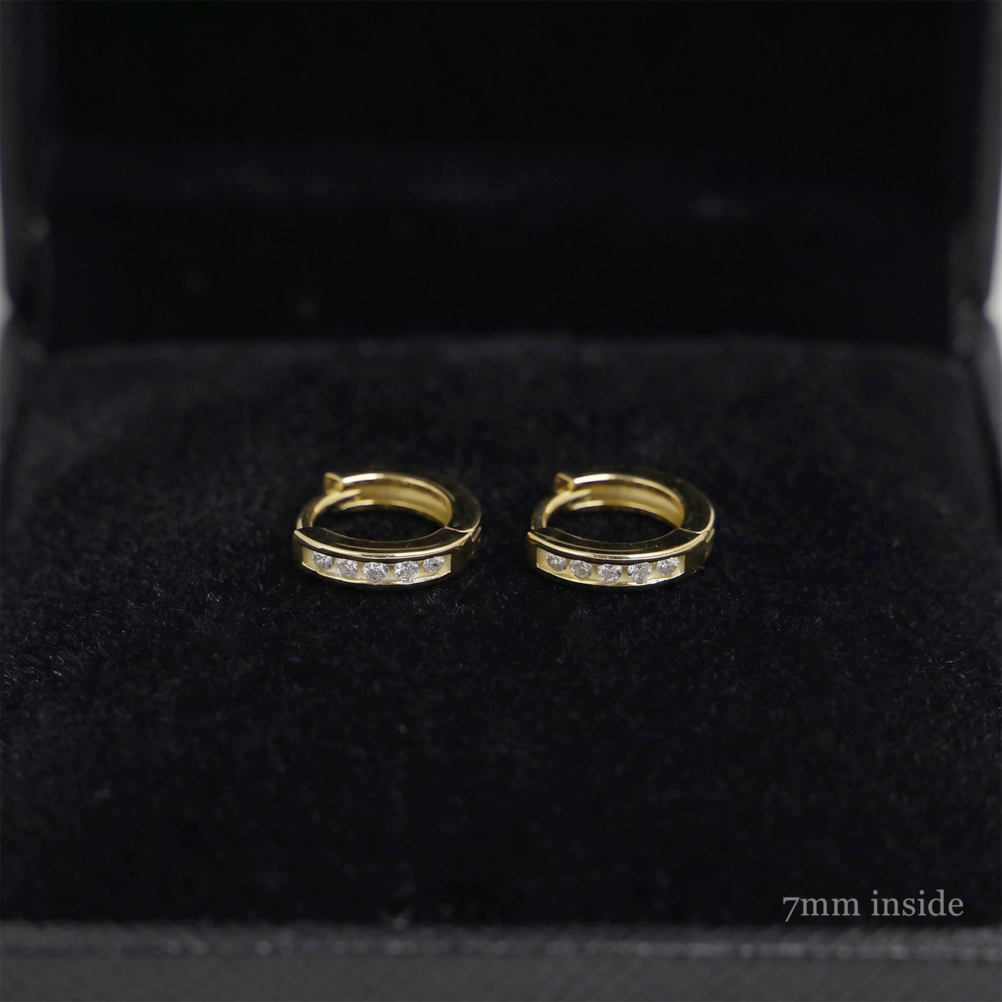 Channel Huggie Hoop earrings, gold tone with clear stone row; 7mm inside