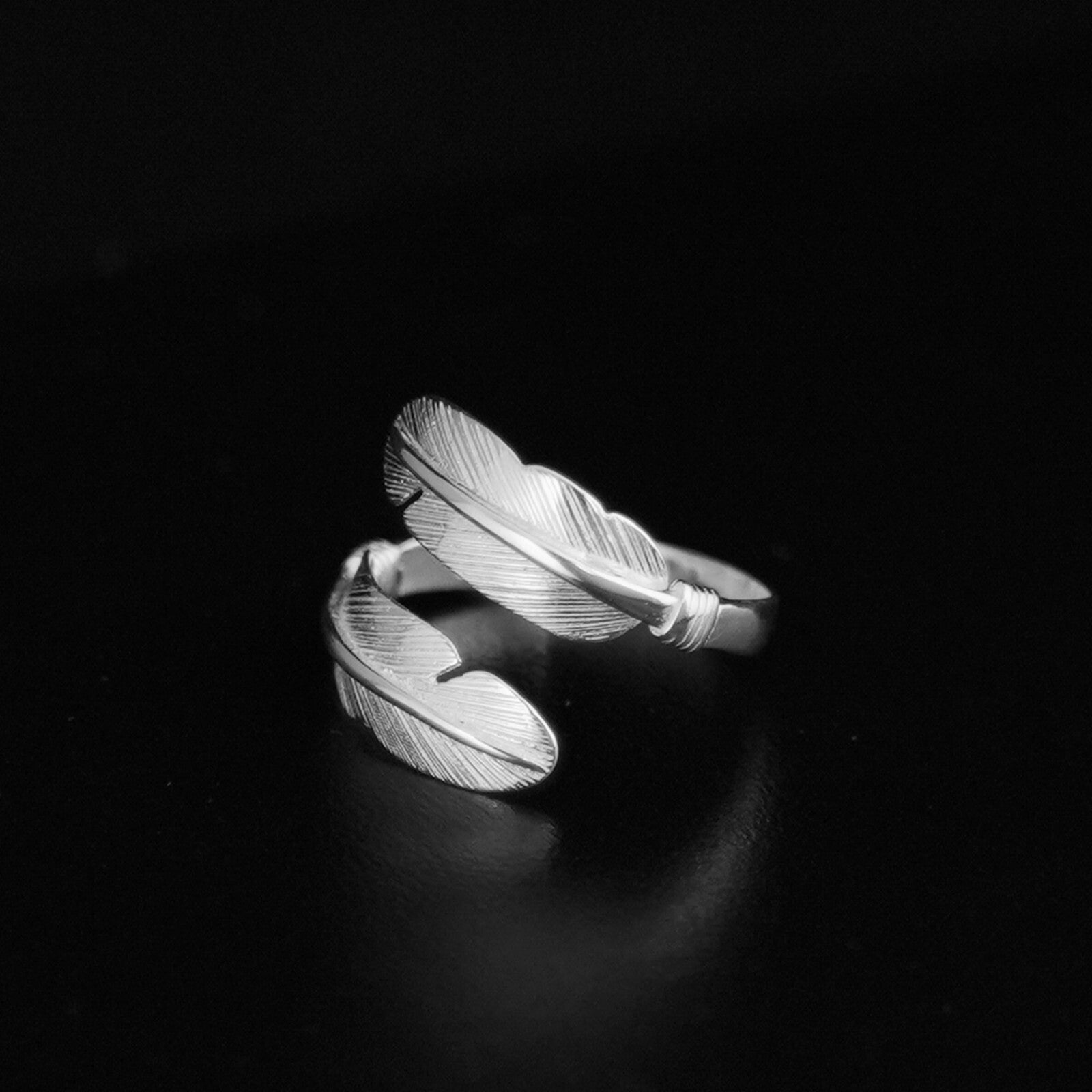 Double feather open band ring with twisted wrap, silver tone